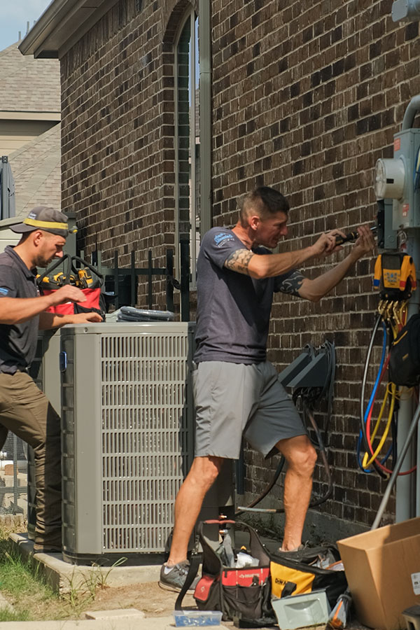 Dragon Air technicians performing repair service on an AC unit in Plano, TX.