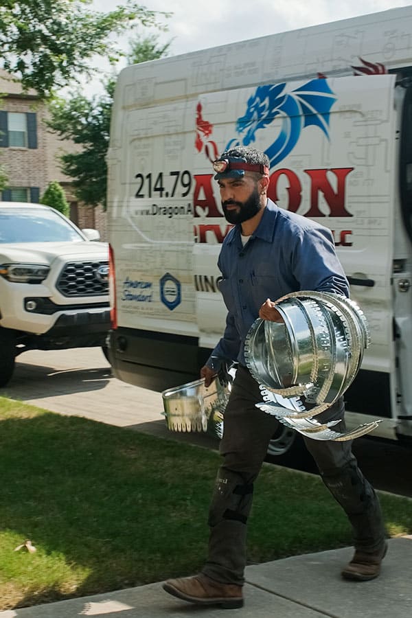 Dragon Air technician carrying air duct custom designed replacement parts in Plano TX.